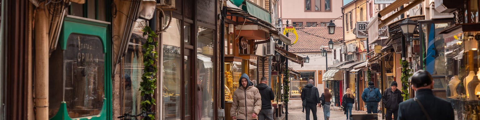 People walking down the streets of Skopje's Old Bazaar in winter