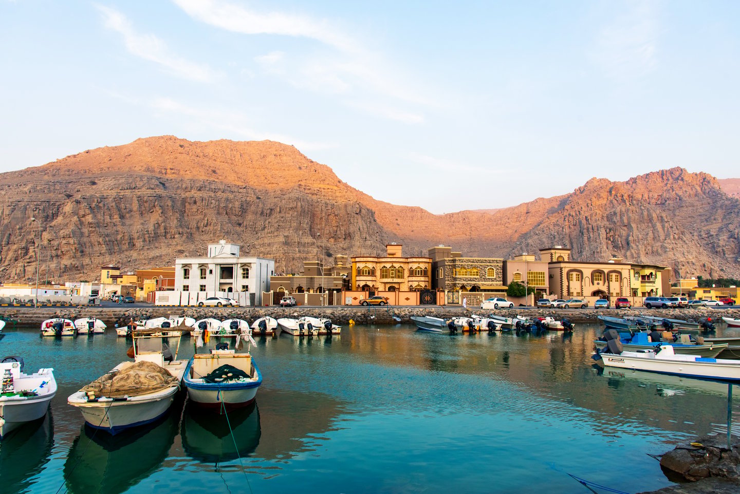 Khasab city, the creek and desert rock scenery with characteristic Arabian houses at sunset