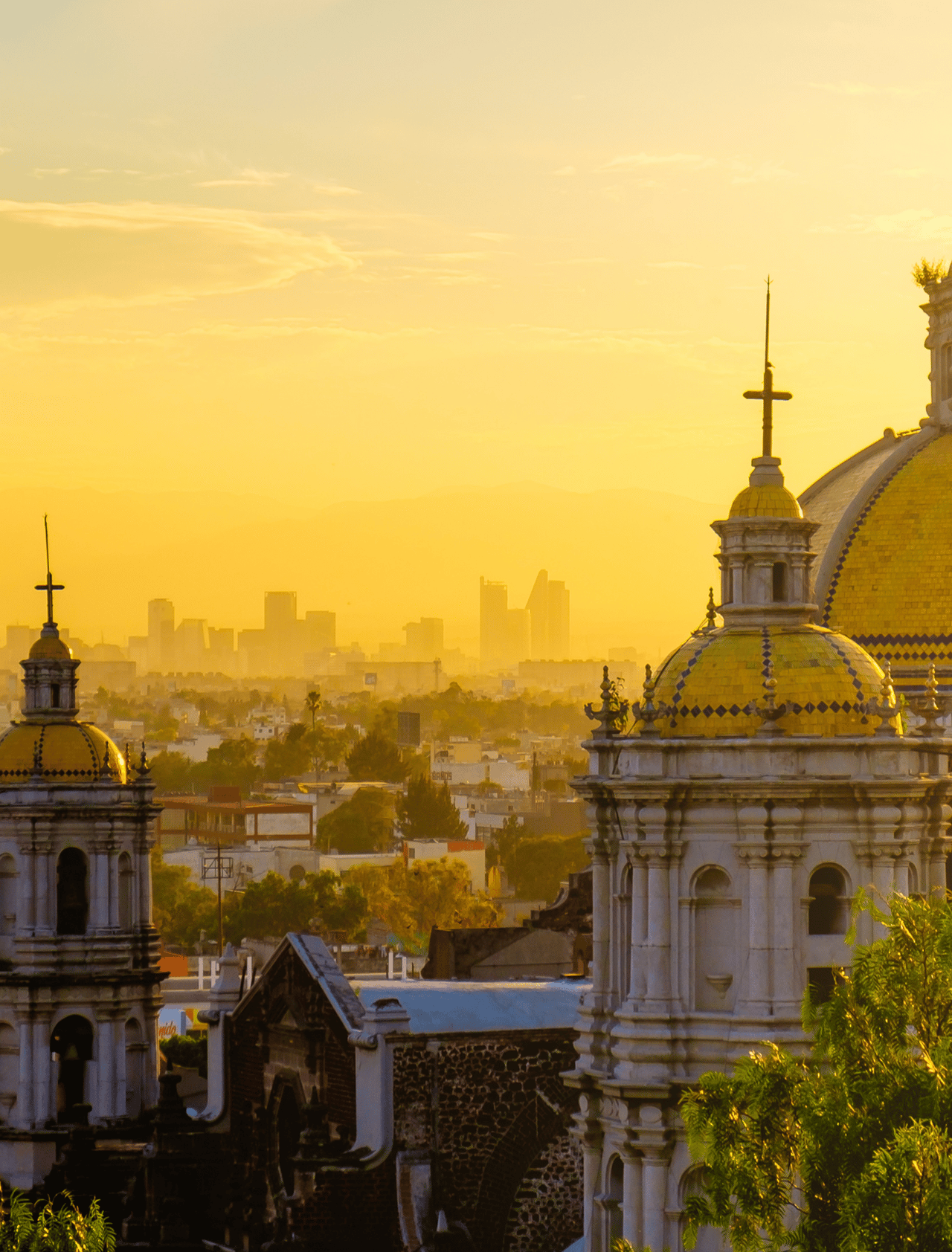 Scenic view at Basilica of Guadalupe with Mexico City skyline at sunset