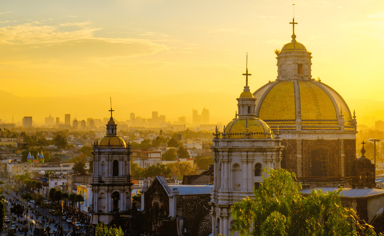 Scenic view at Basilica of Guadalupe with Mexico City skyline at sunset