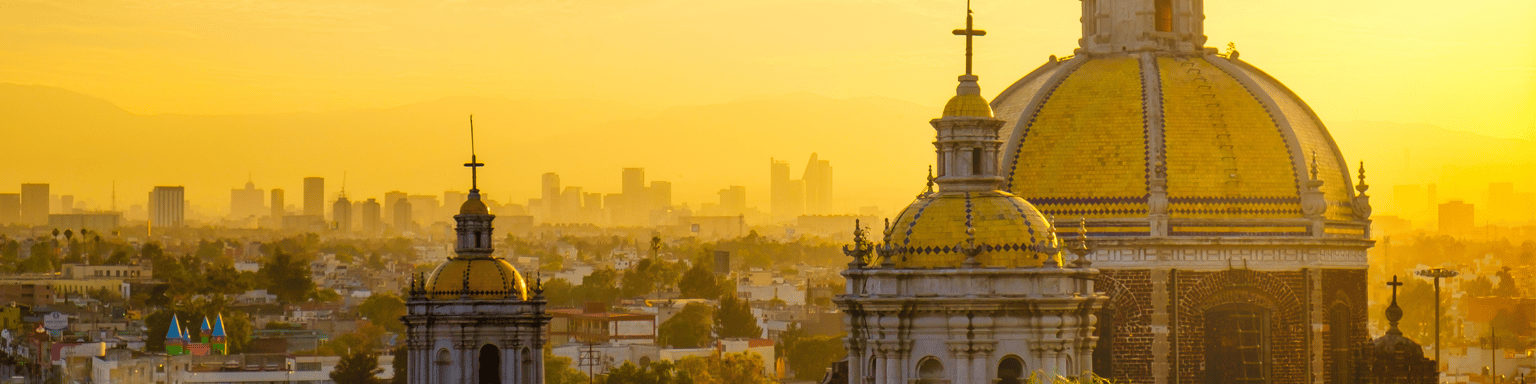 Scenic view at Basilica of Guadalupe with Mexico City skyline at sunset