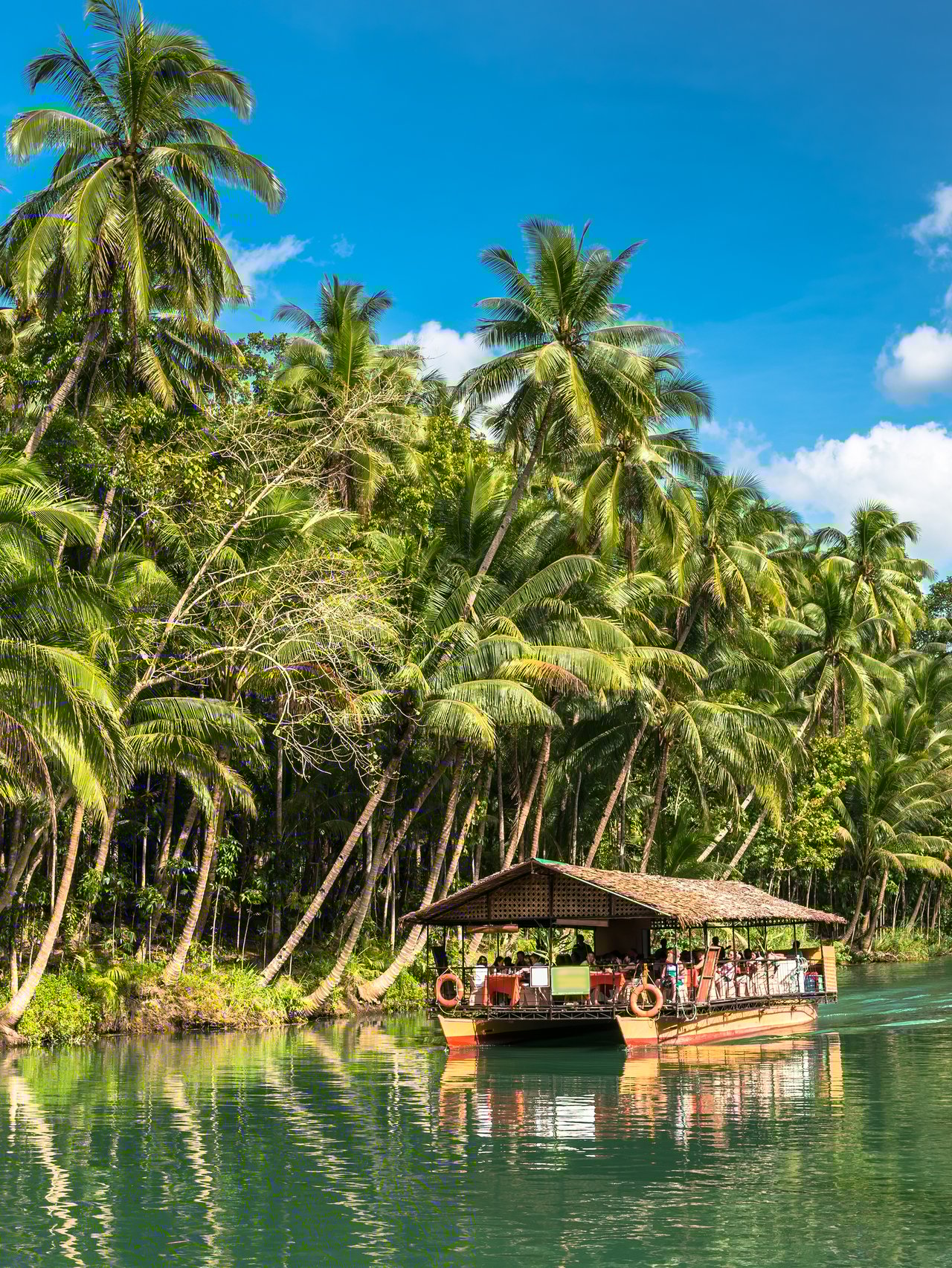 A cruise on a traditional raft boat for tourists at Bohol island