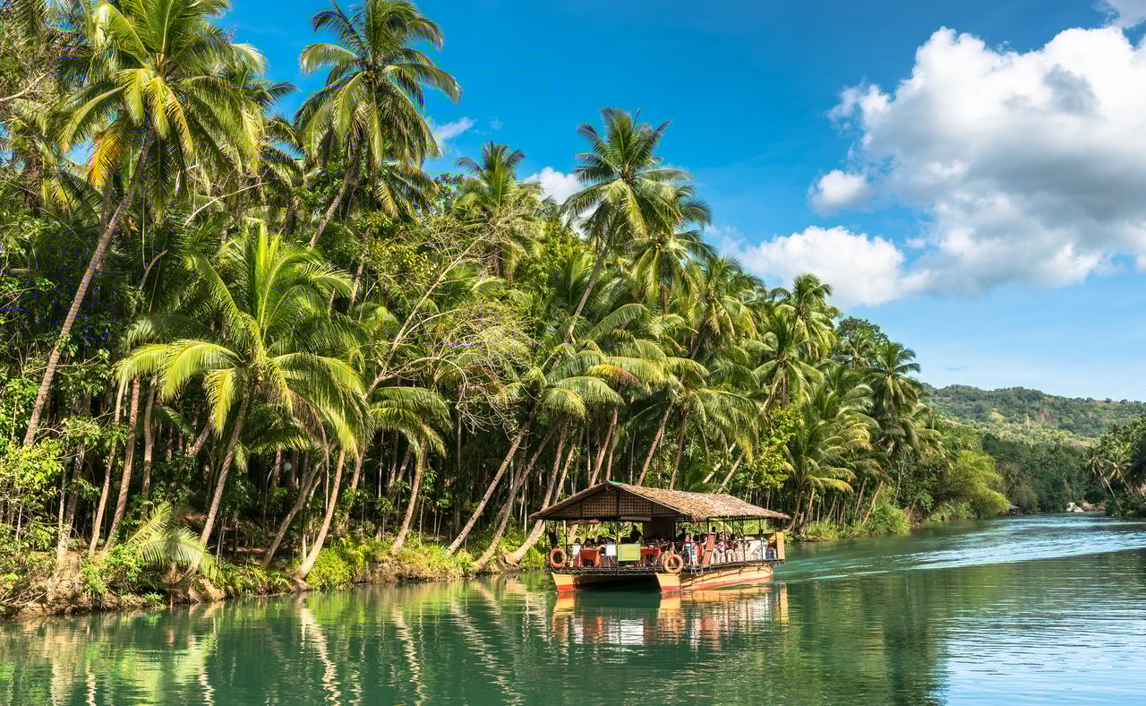 A cruise on a traditional raft boat for tourists at Bohol island