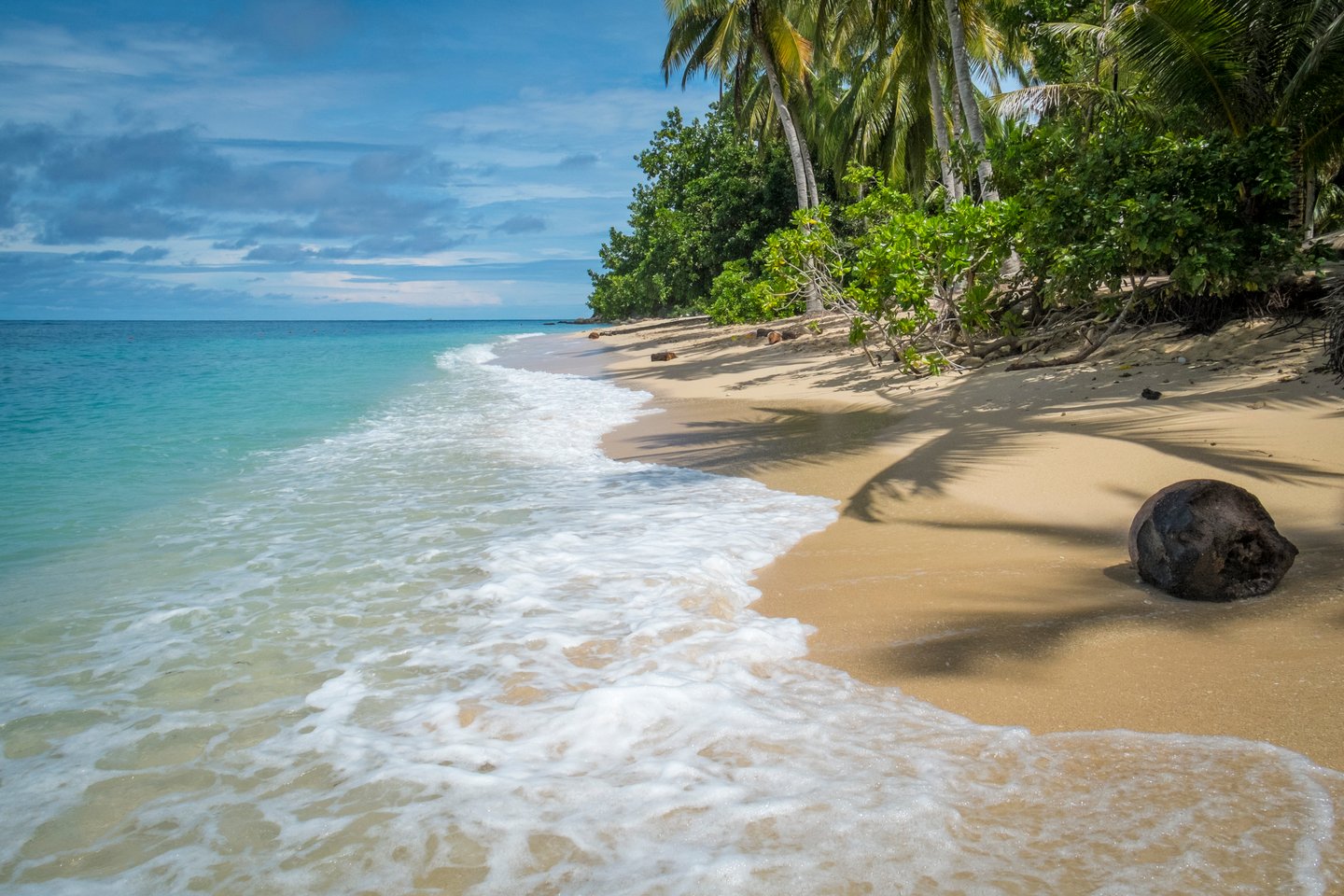 Waves lapping against the sand on a beach on Samal Island