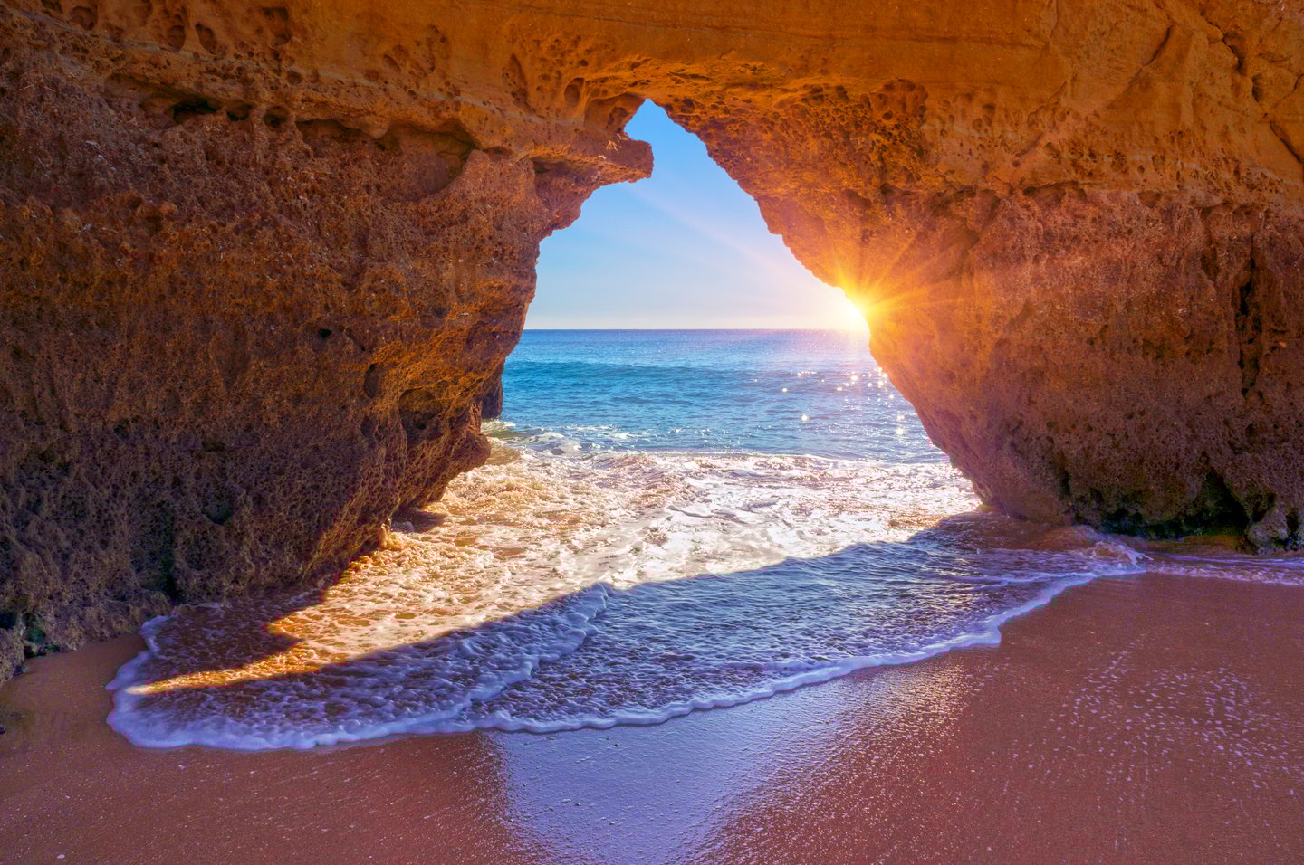 Sunlight and seawater coming through an opening in Benagil Cave, Portugal