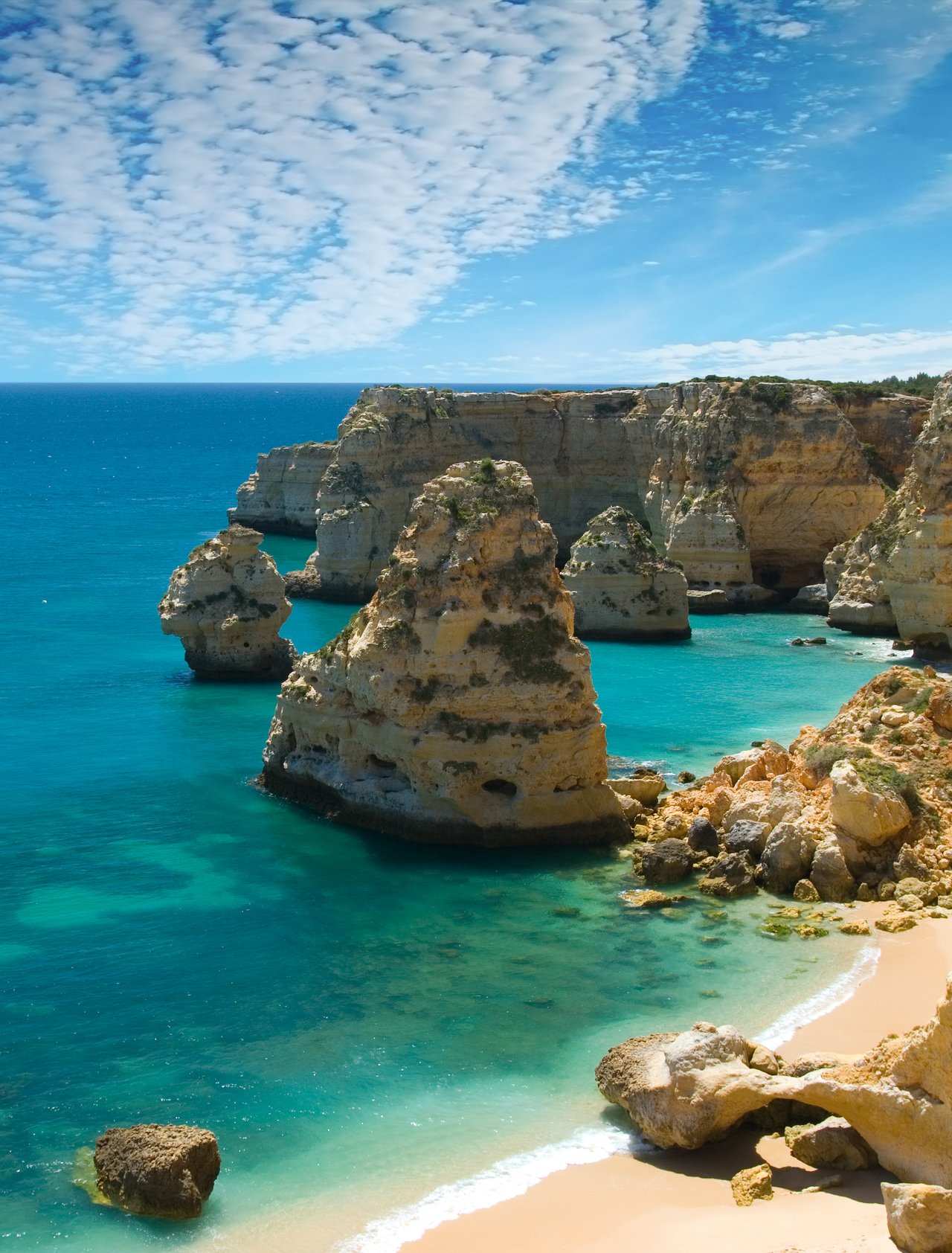 Rocks and a white, sandy beach in Marinha Cove, Portugal