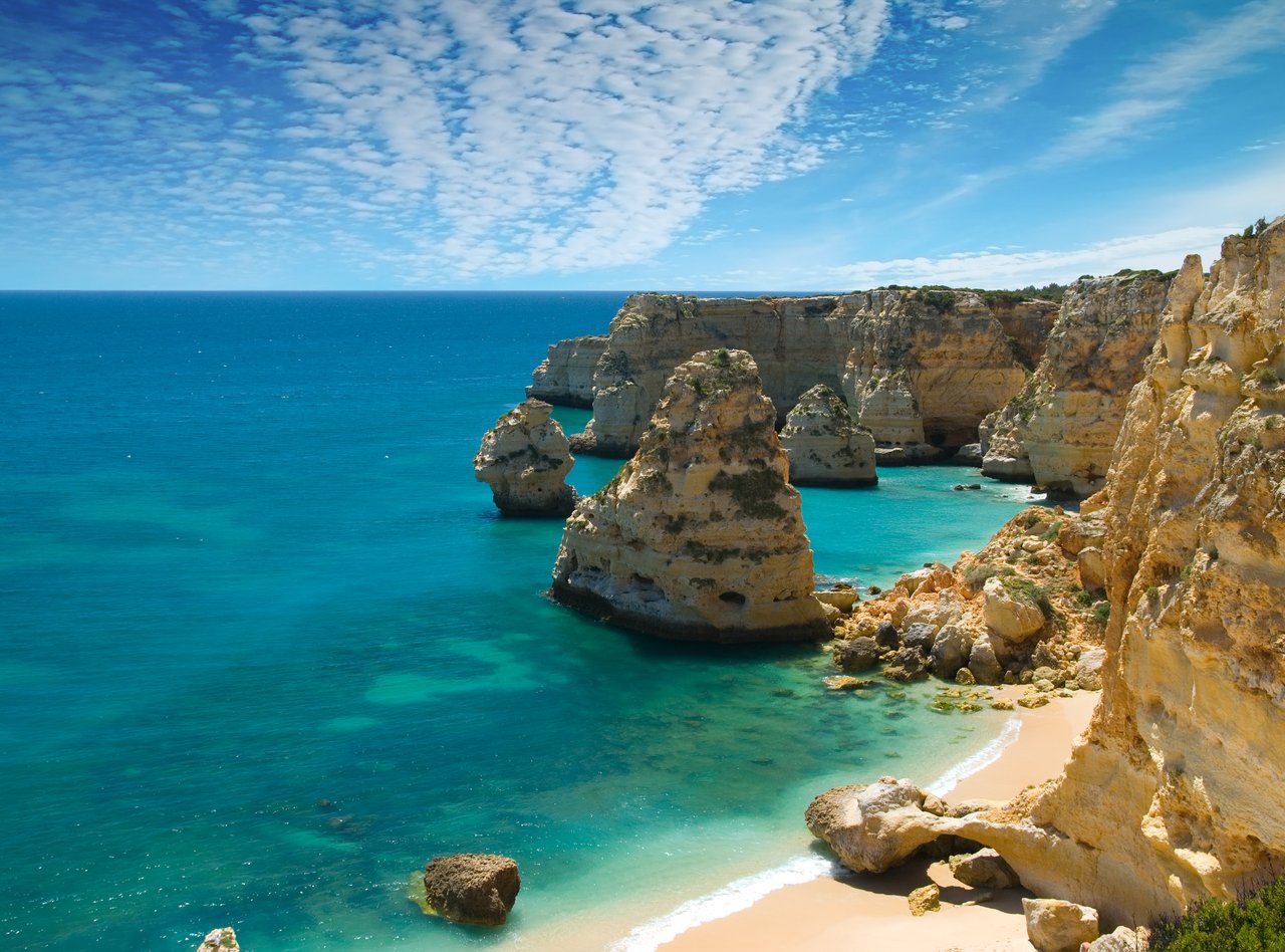 Rocks and a white, sandy beach in Marinha Cove, Portugal