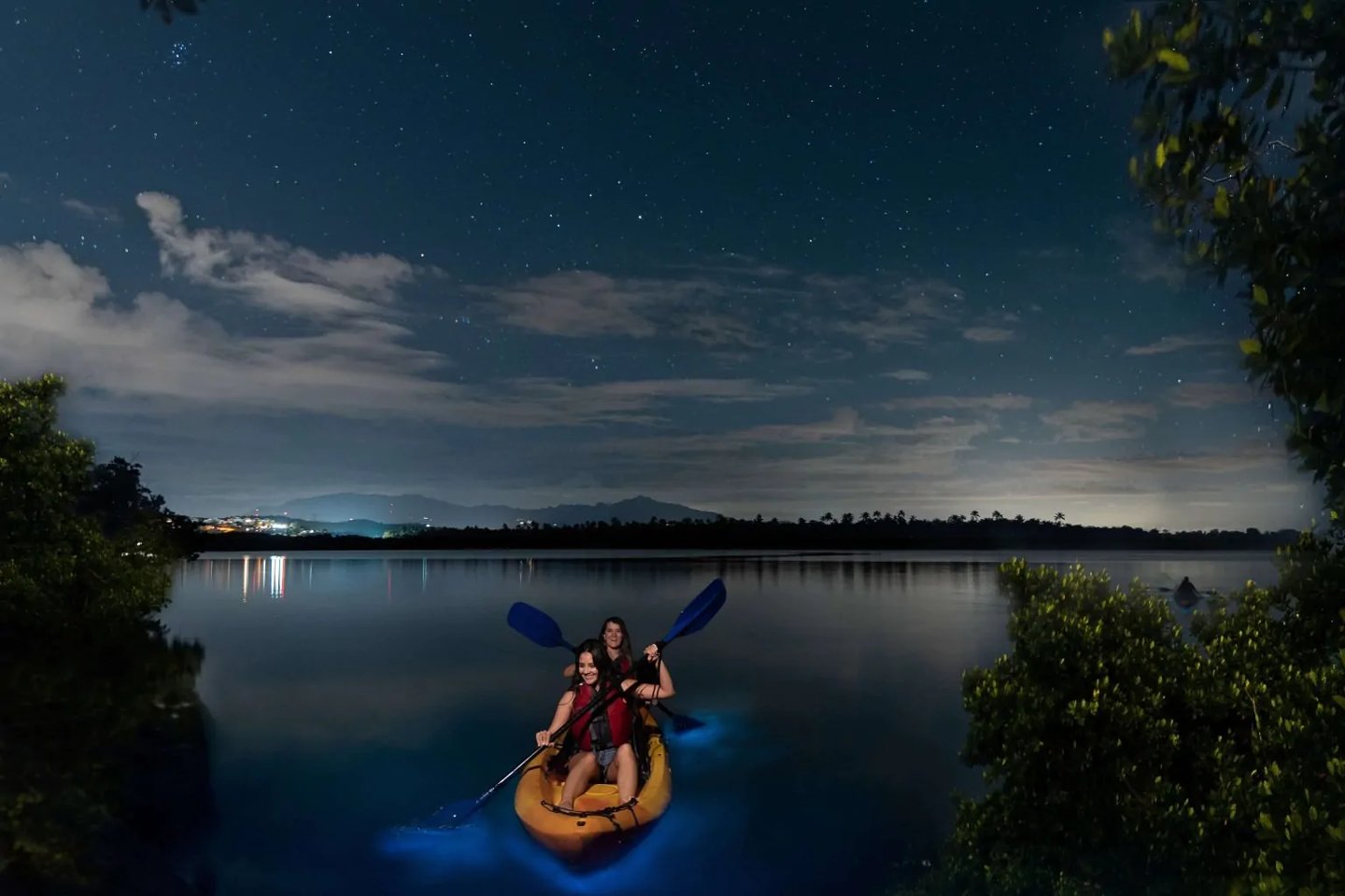 Kayaking in Grande Lunga, Puerto Rico, with bioluminescence visible around the kayak