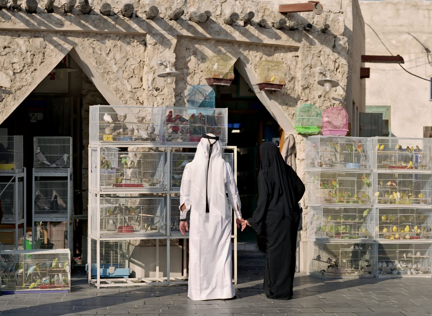 A couple standing outside a bird shop in Doha, Qatar
