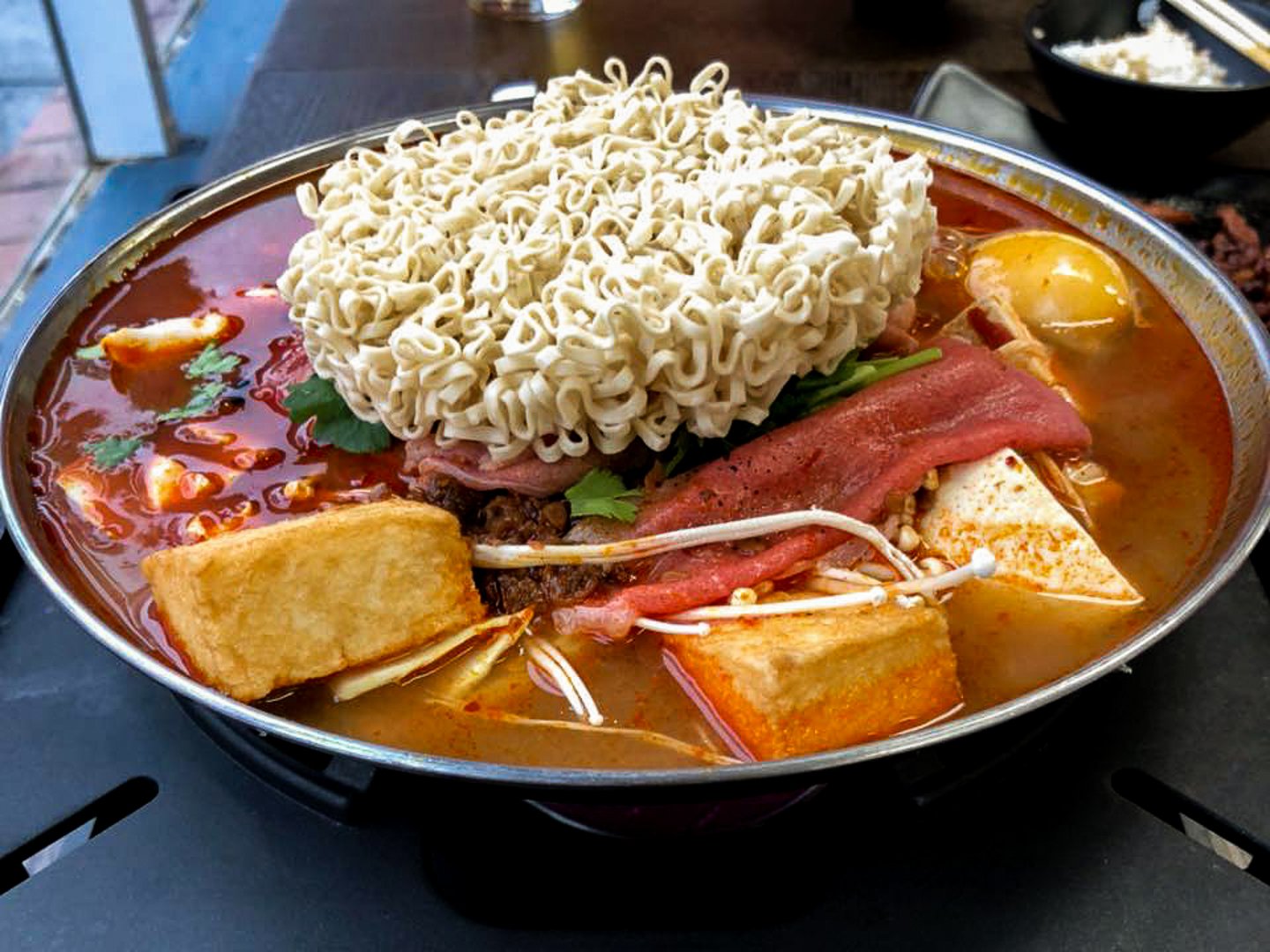 A hot pot with meat, tofu, noodles and soup at Number One Hot Pot