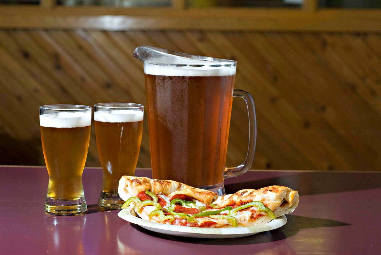 Beer and pizza on a table