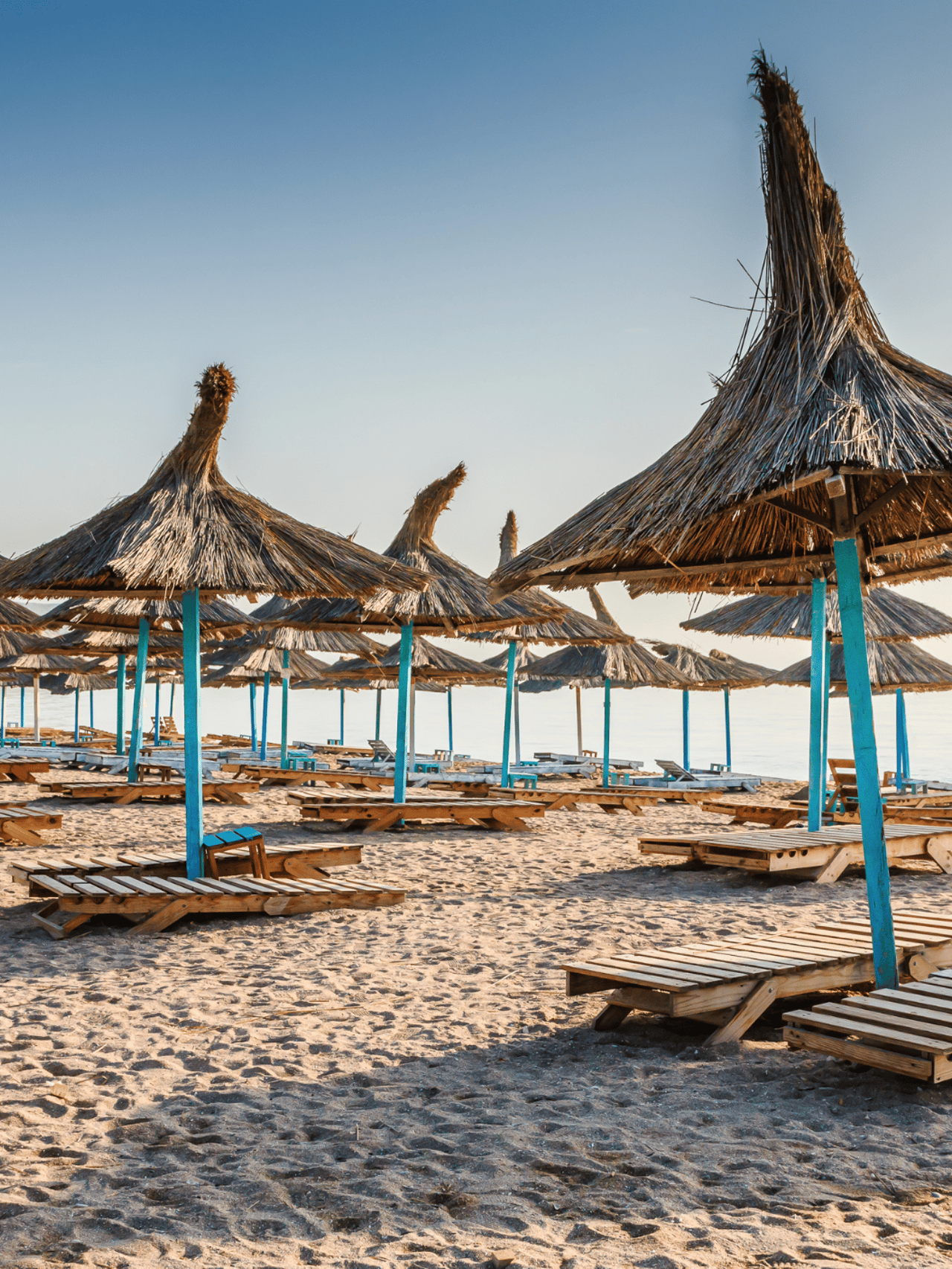 Straw umbrellas on the beach in Vama Veche village, Romania