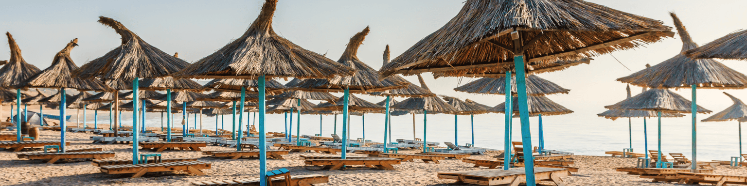 Straw umbrellas on the beach in Vama Veche village, Romania