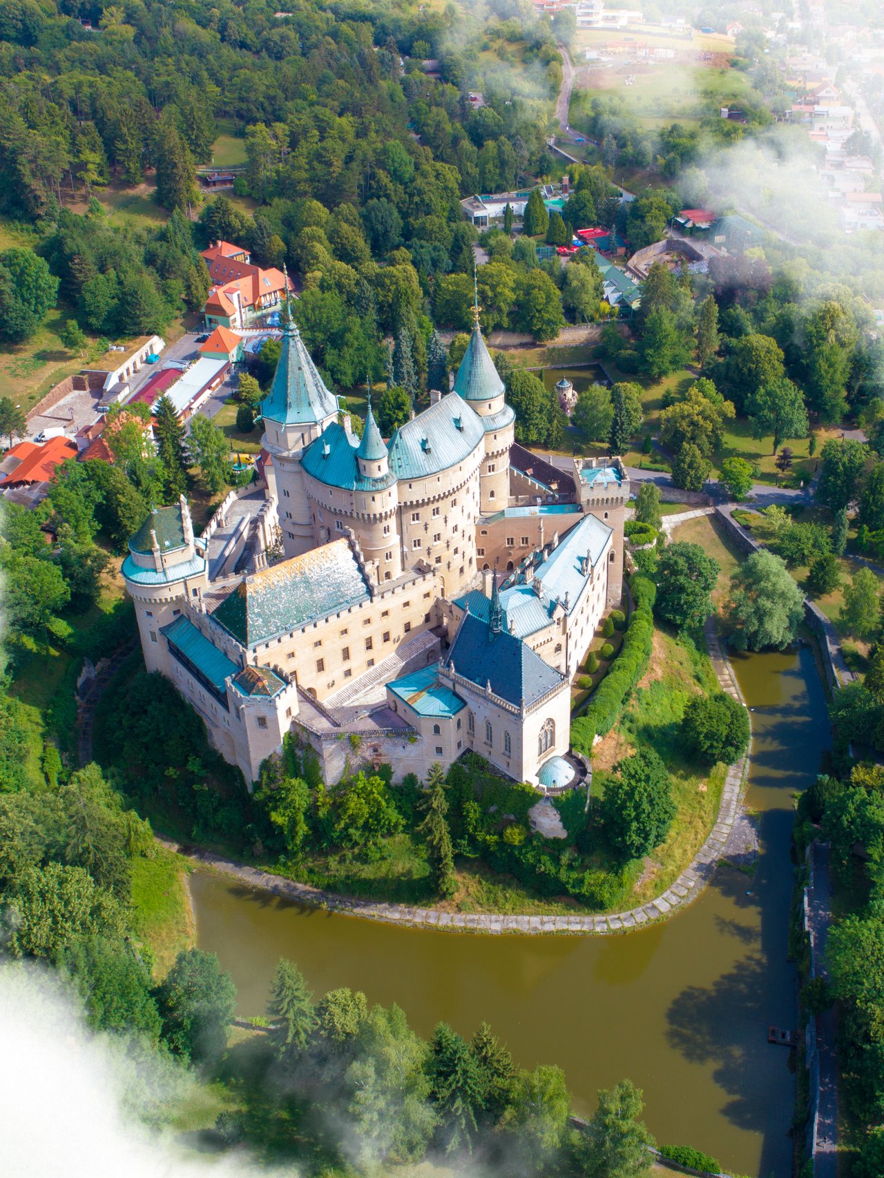 An aerial view of Bojnice Castle and the surrounding lake