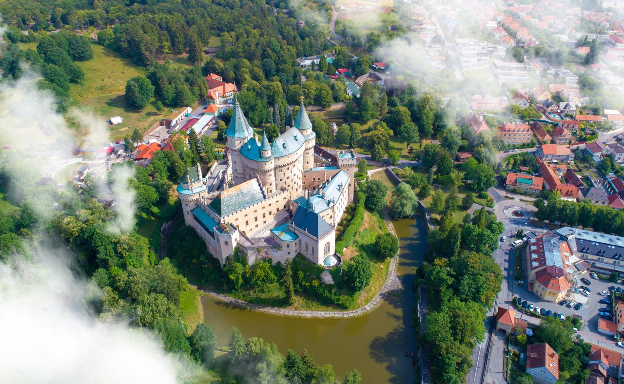 An aerial view of Bojnice Castle and the surrounding lake
