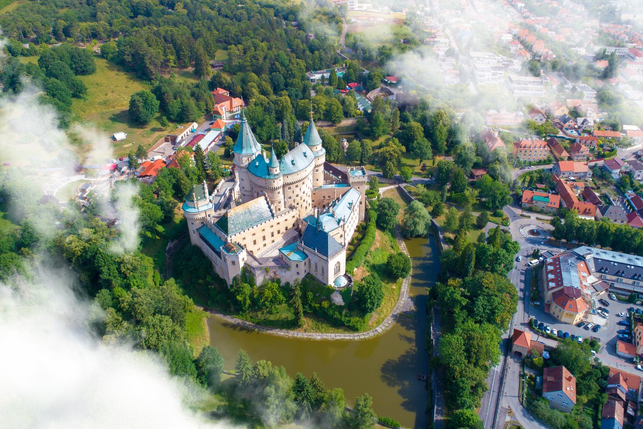 An aerial view of Bojnice Castle and the surrounding lake