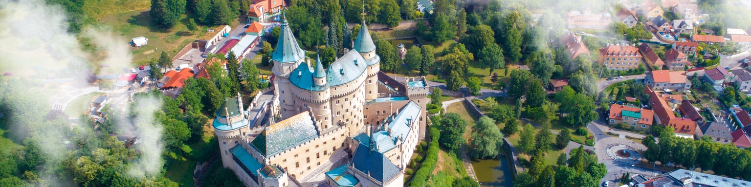 An aerial view of Bojnice Castle and the surrounding lake