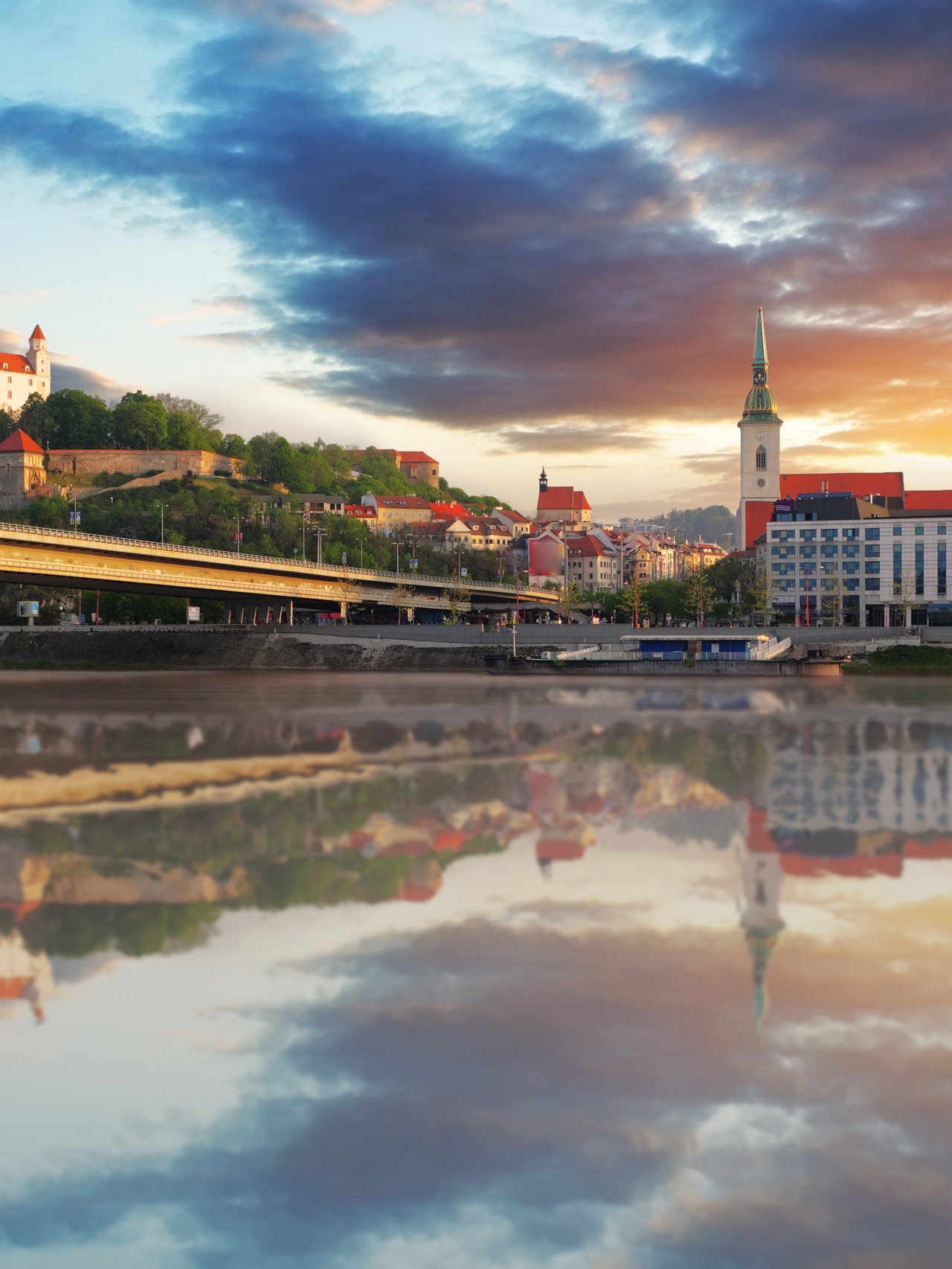 The Danube flowing through Bratislava with the old town and castle in the distance