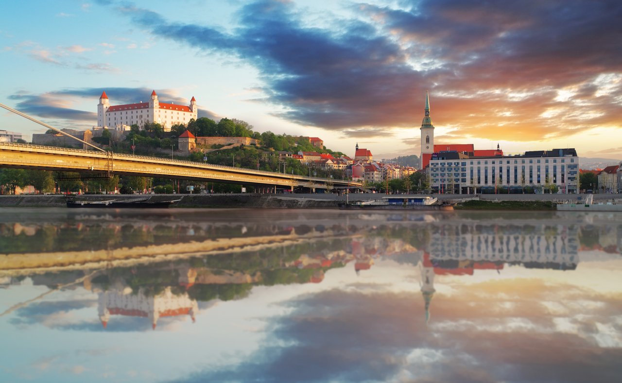 The Danube flowing through Bratislava with the old town and castle in the distance