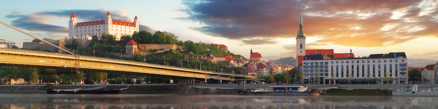 The Danube flowing through Bratislava with the old town and castle in the distance