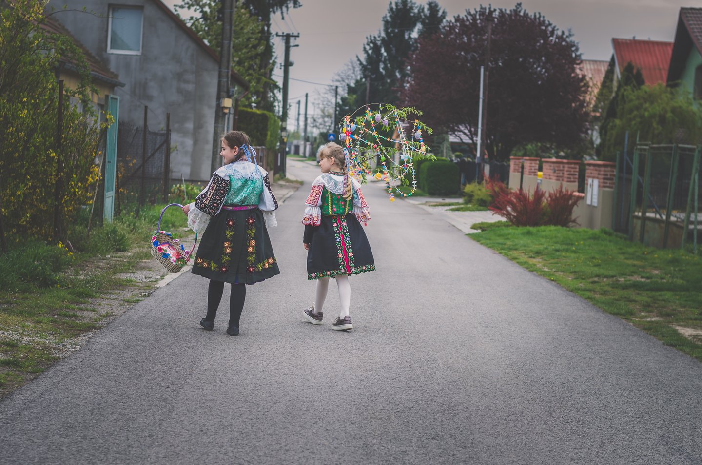 Girls walking down the road in Slovakia dressed in traditional folk costumes