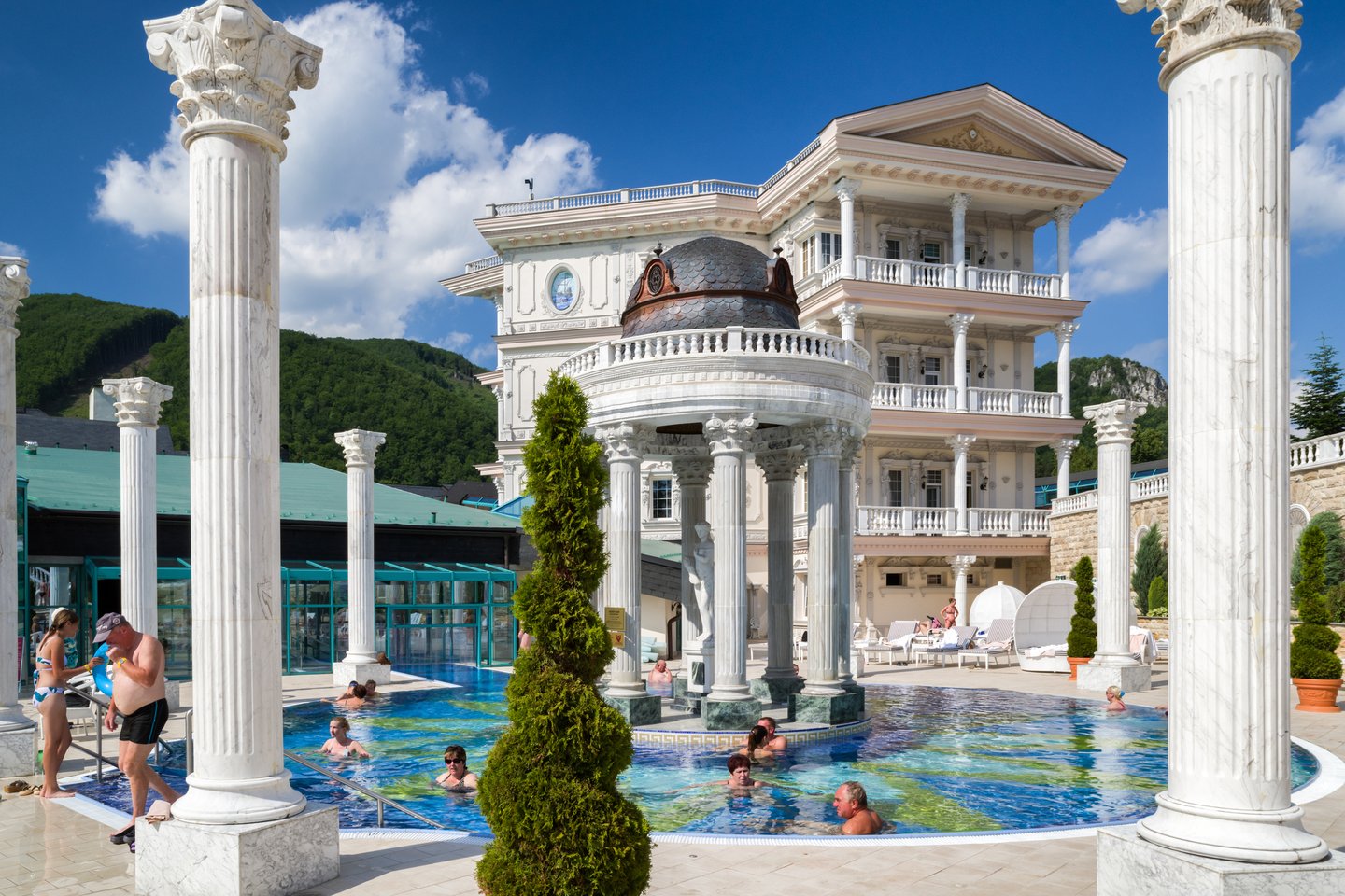 People swimming in an outdoor pool at Aprohrodite Spa in Rajecké Teplice, Slovakia
