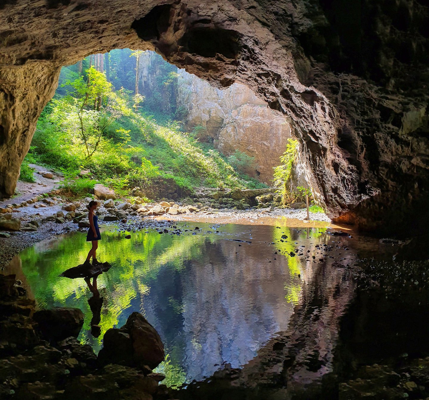 A girl standing near the exit of the Skocjan Caves in Slovenia