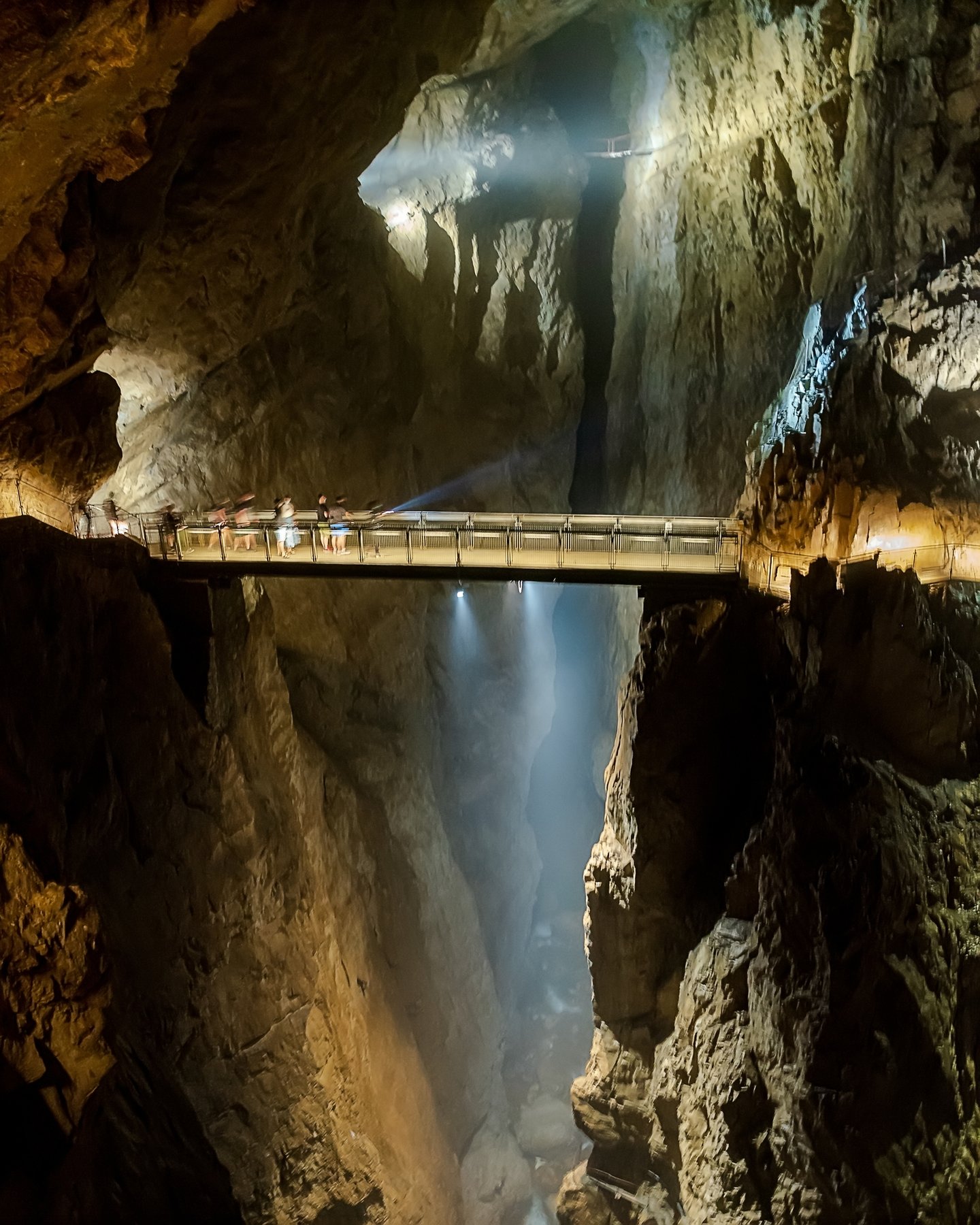 The Cerkvenikov Most, a narrow bridge, over a deep chasm in the Skocjan Caves, Slovenia