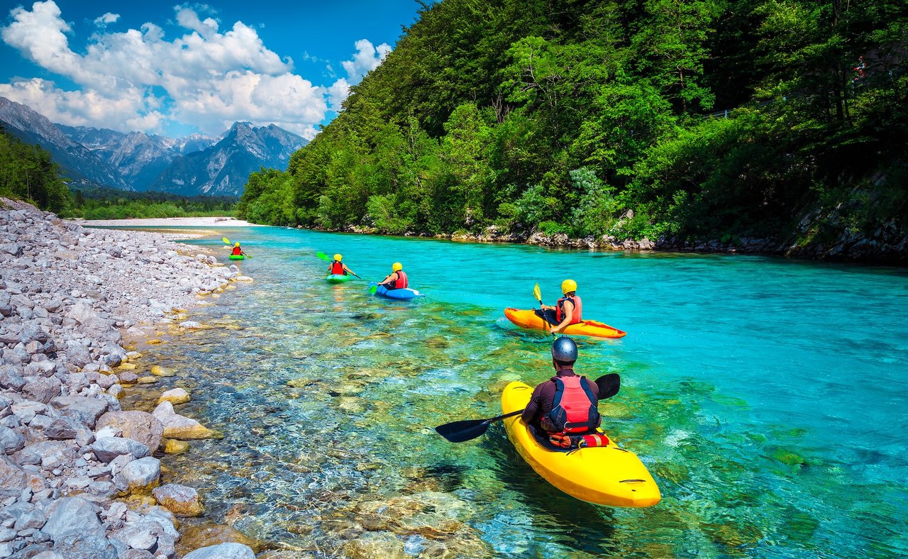Kayaking down the pristine blue waters of the Soca River in Slovenia