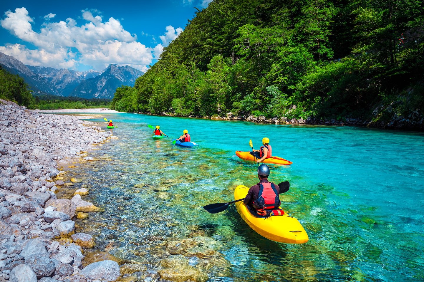 Kayaking down the pristine blue waters of the Soca River in Slovenia