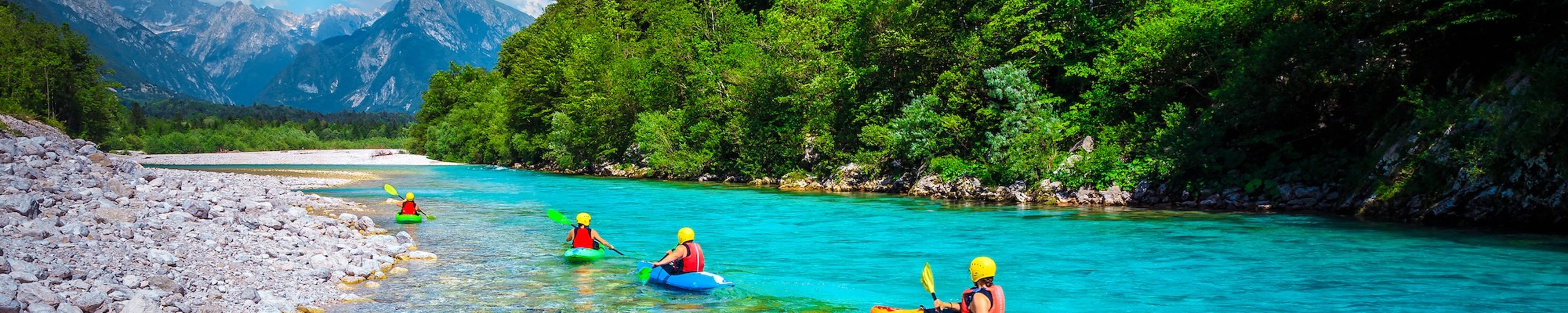 Kayaking down the pristine blue waters of the Soca River in Slovenia