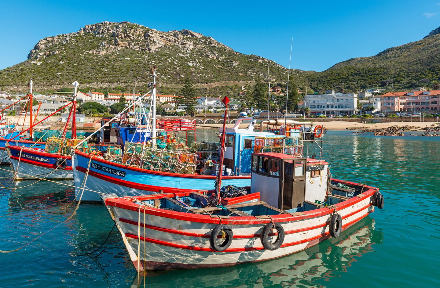 Fishing boats in Kalk Bay Harbour on a sunny day.