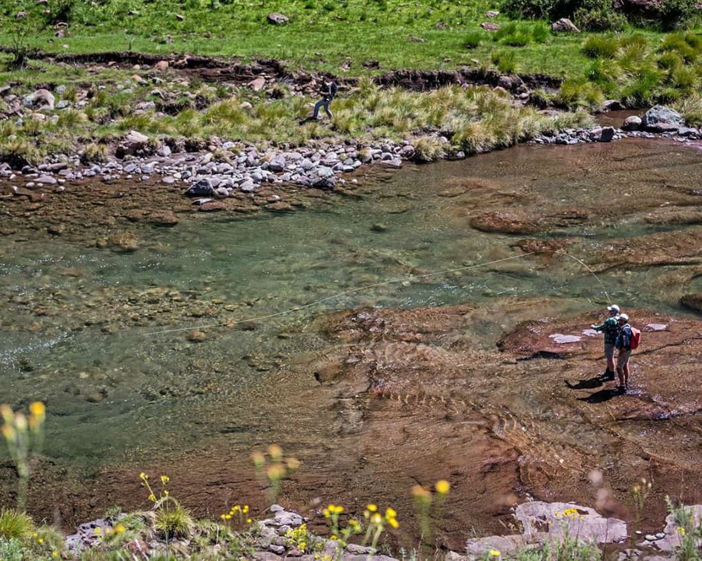 People fishing in a river in Clarens, South Africa
