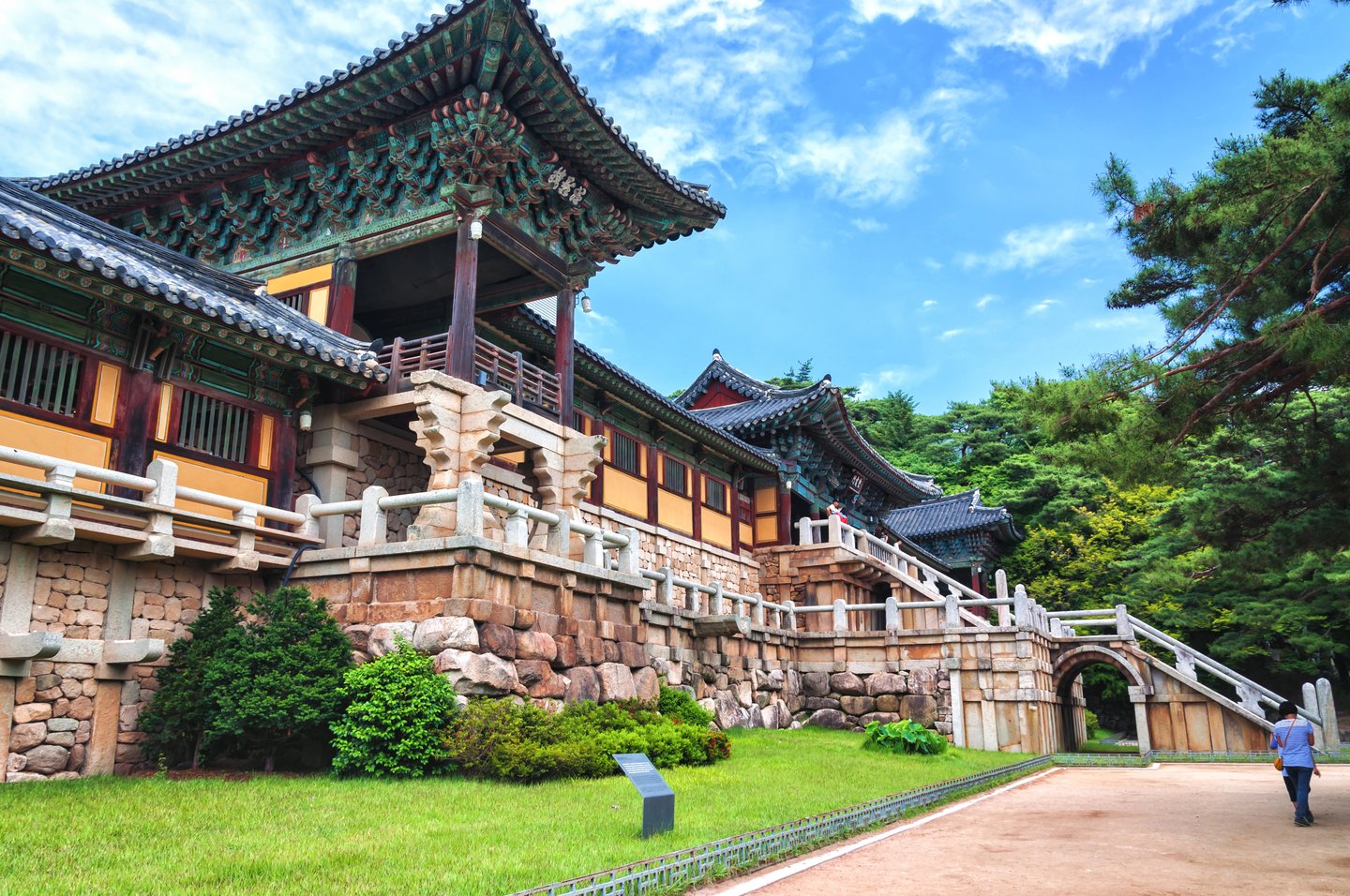 A person walking in front of the majestic Bulguksa Temple in Gyeongju, South Korea