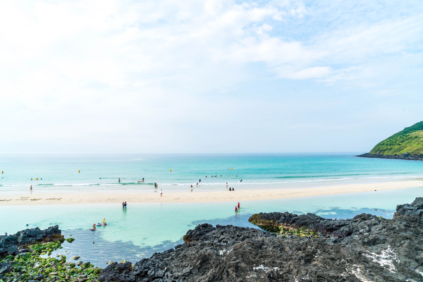 People swimming at Hamdeok Beach in Jeju Island