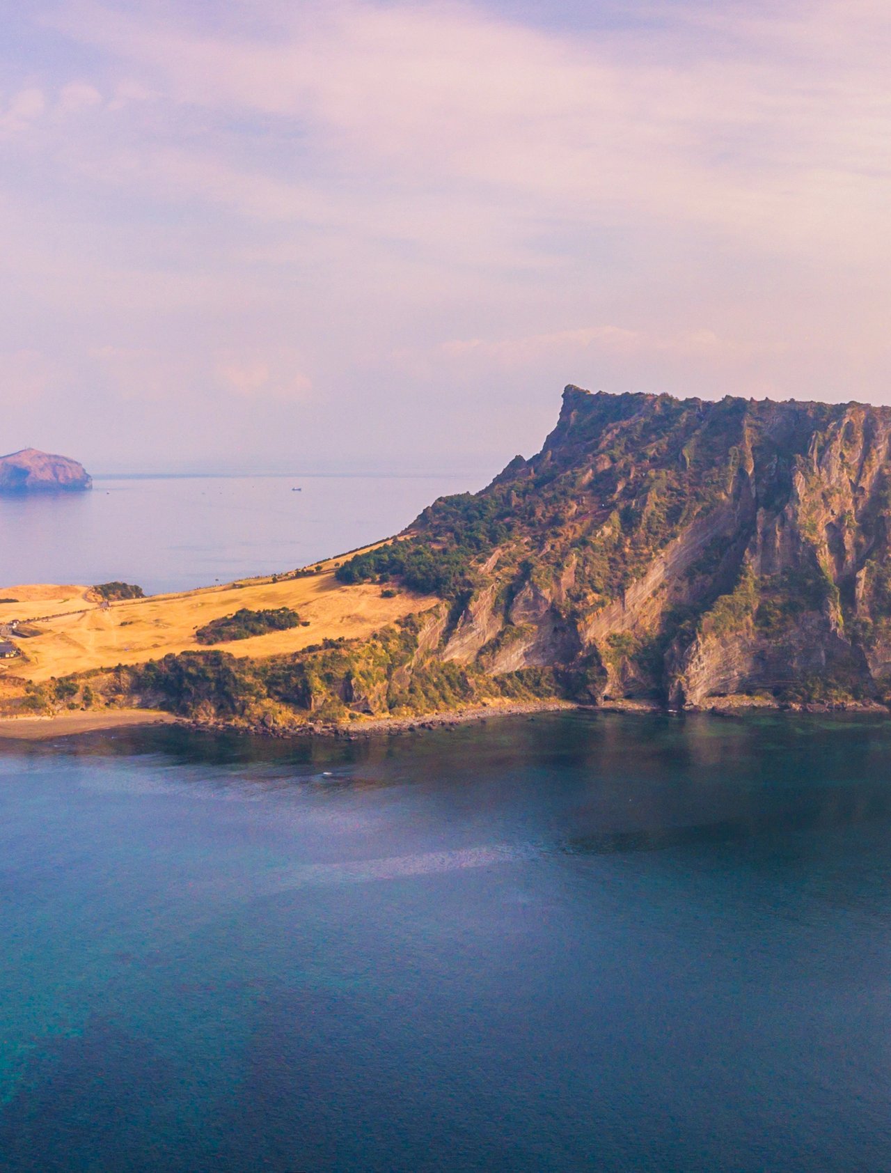 Jeju Do City and Seongsan Ilchulbong at sunrise in Jeju Island, South Korea