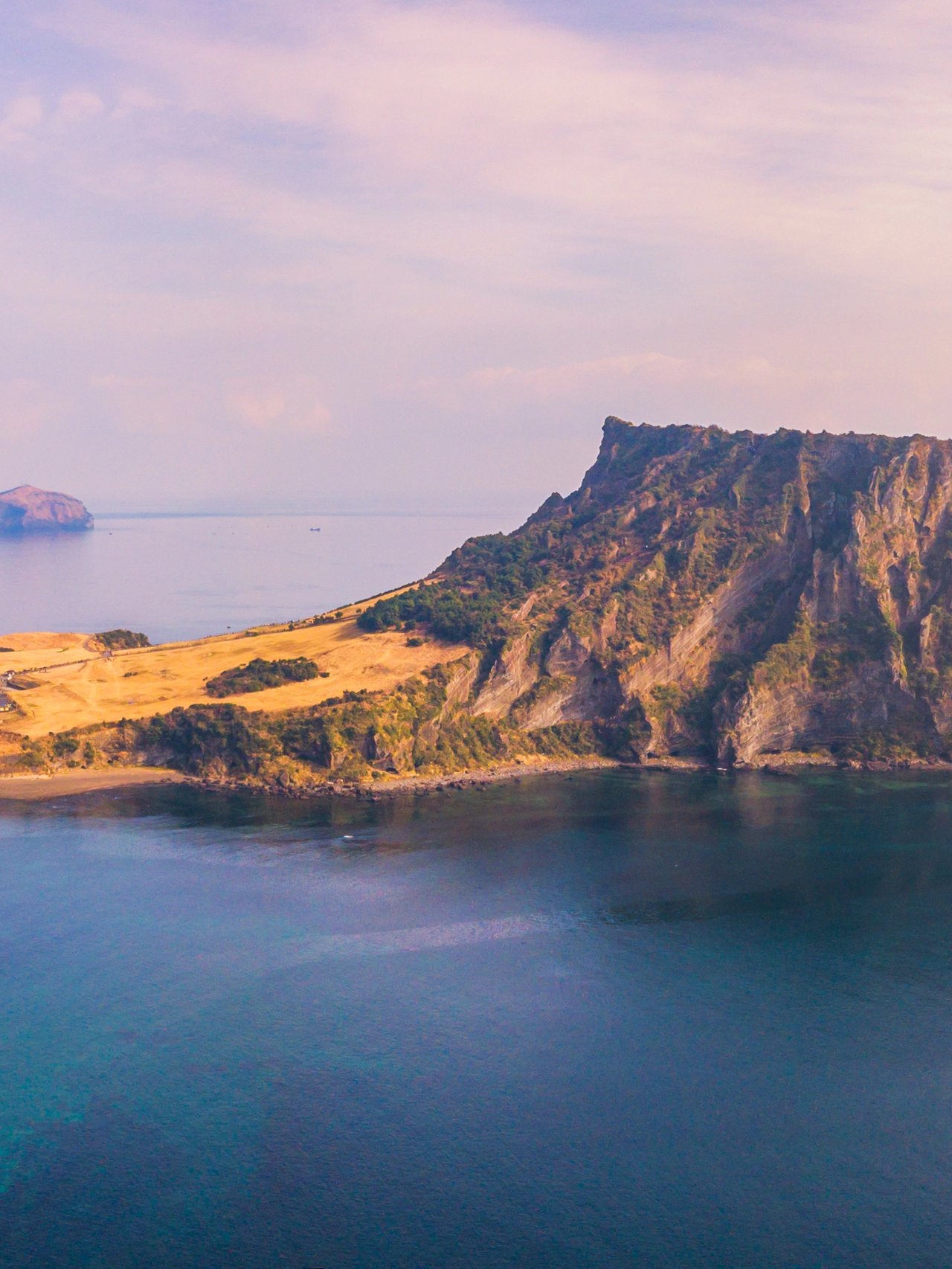 Jeju Do City and Seongsan Ilchulbong at sunrise in Jeju Island, South Korea