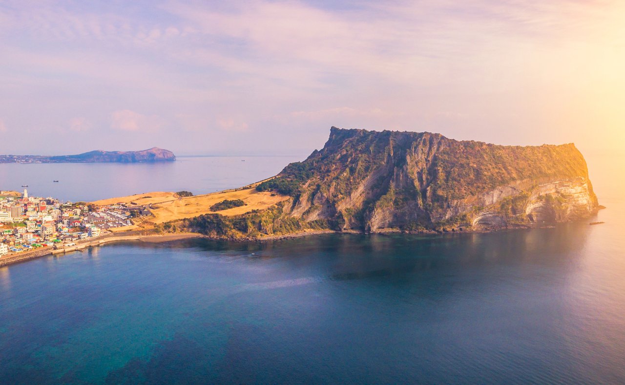 Jeju Do City and Seongsan Ilchulbong at sunrise in Jeju Island, South Korea