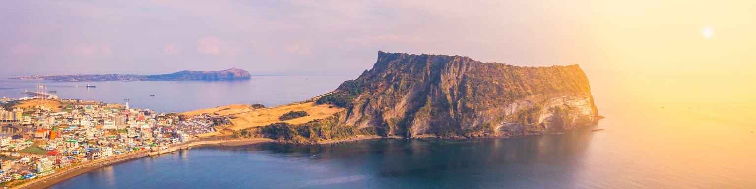 Jeju Do City and Seongsan Ilchulbong at sunrise in Jeju Island, South Korea