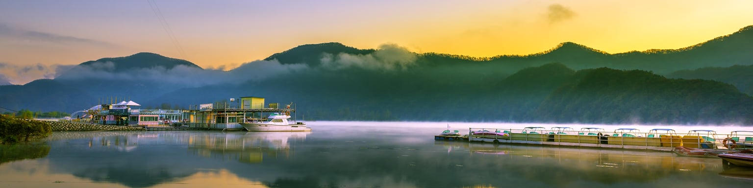 Reflections of the sky and boats in the river at Nami Island port, South Korea.