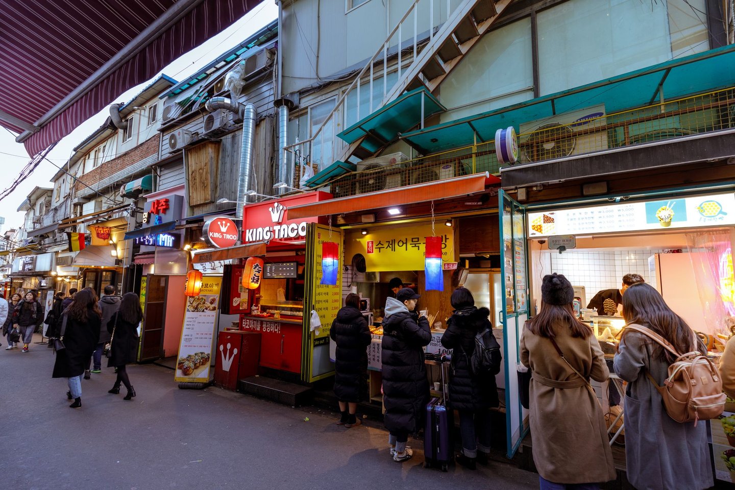 A street lined with shops and eateries in Hongdae, Seoul