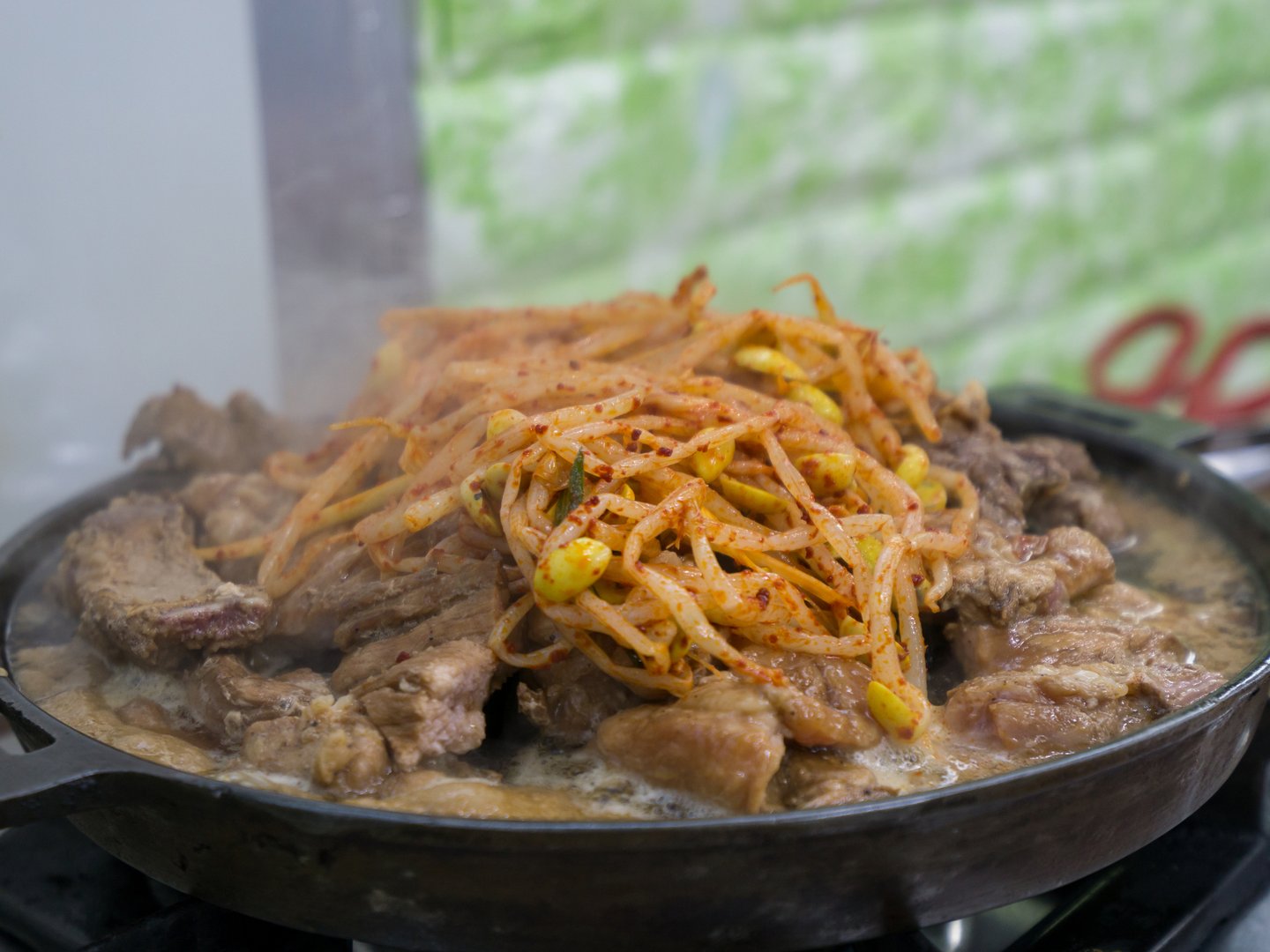Suwon galbi pork ribs, marinated in soy sauce and cooking on a hot pot .