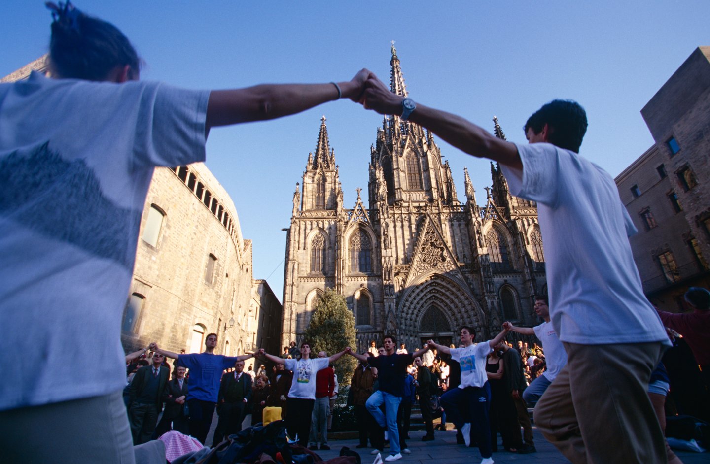 People dancing outside the Santa Eulalia cathedral in Barcelona