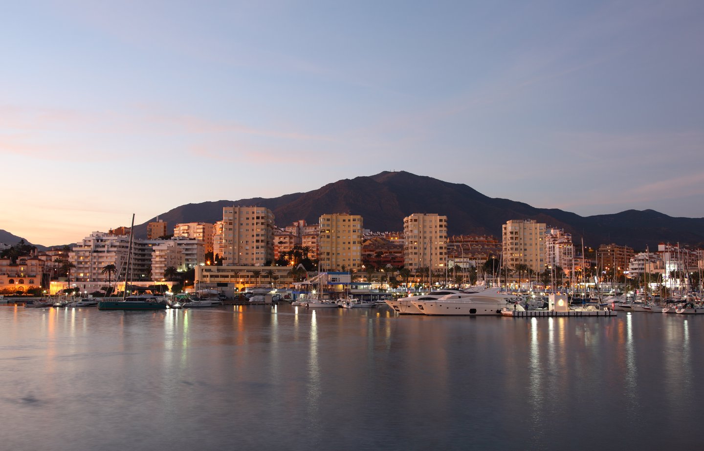 Boats moored at Estepona marina at dusk