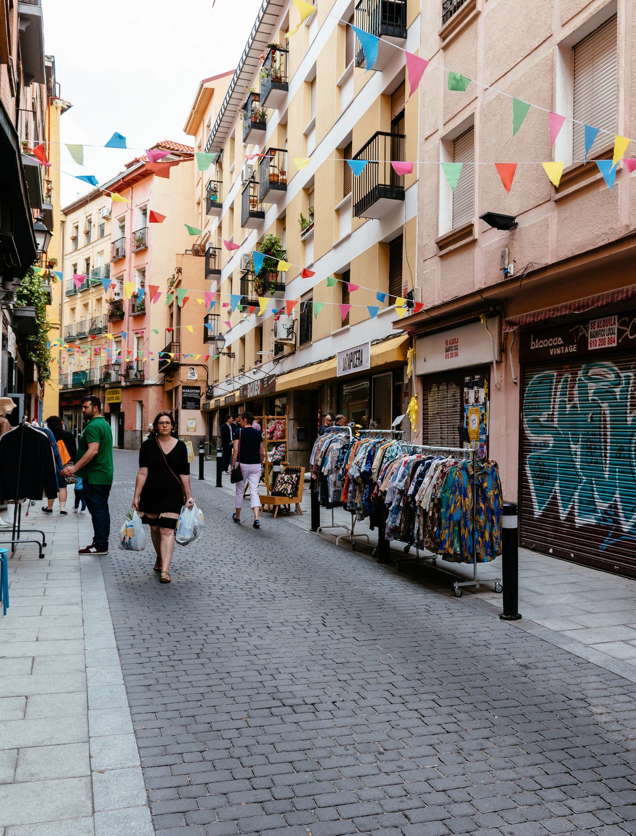 A flea market along a street in Lavapiés, Madrid