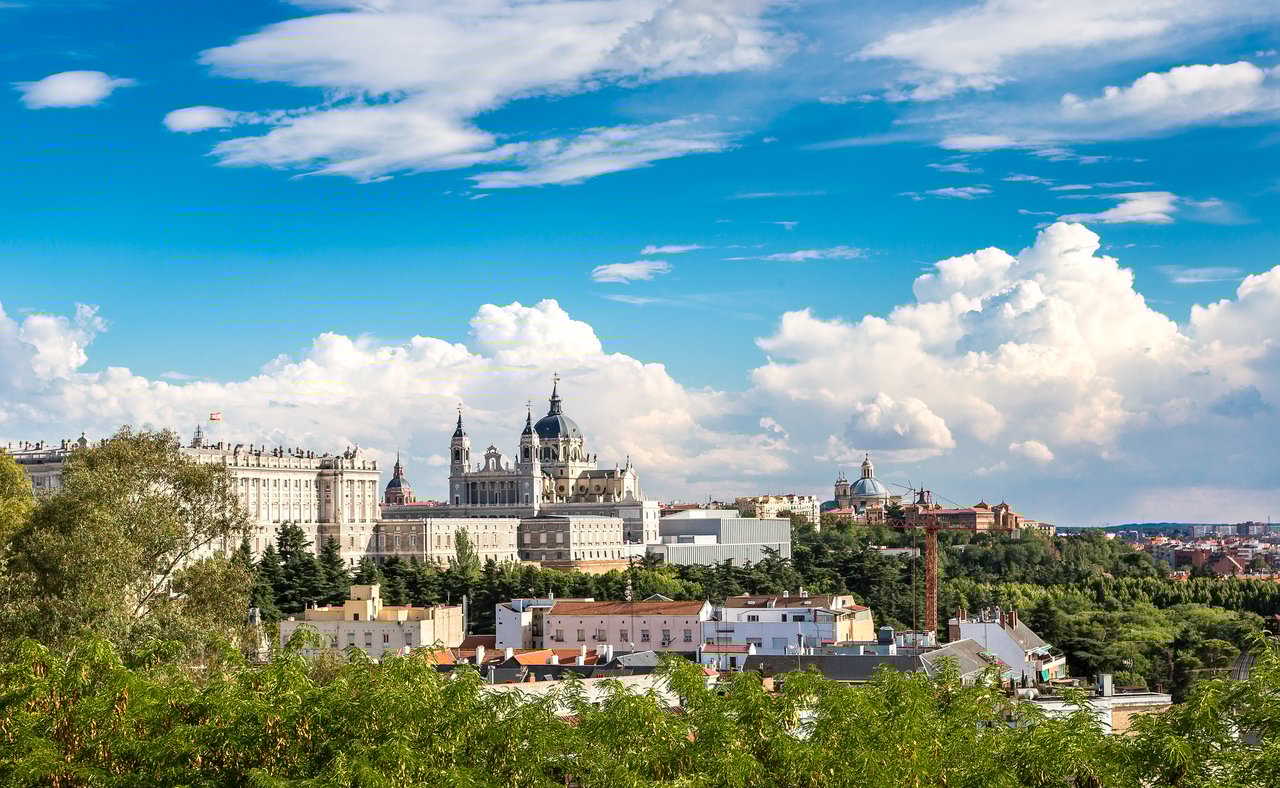 The Madrid skyline visible between trees