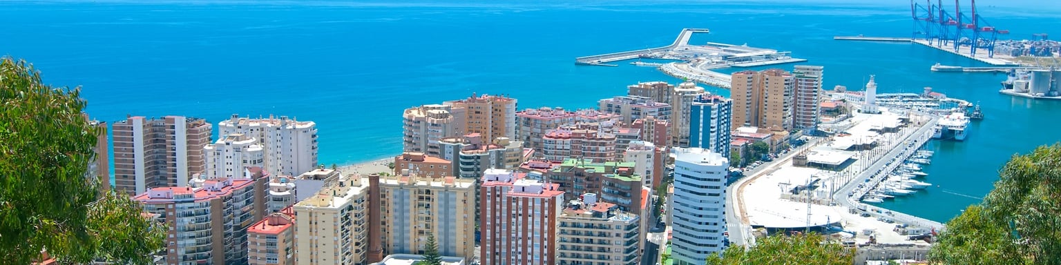 Malaga's bull ring with the harbour in the distance