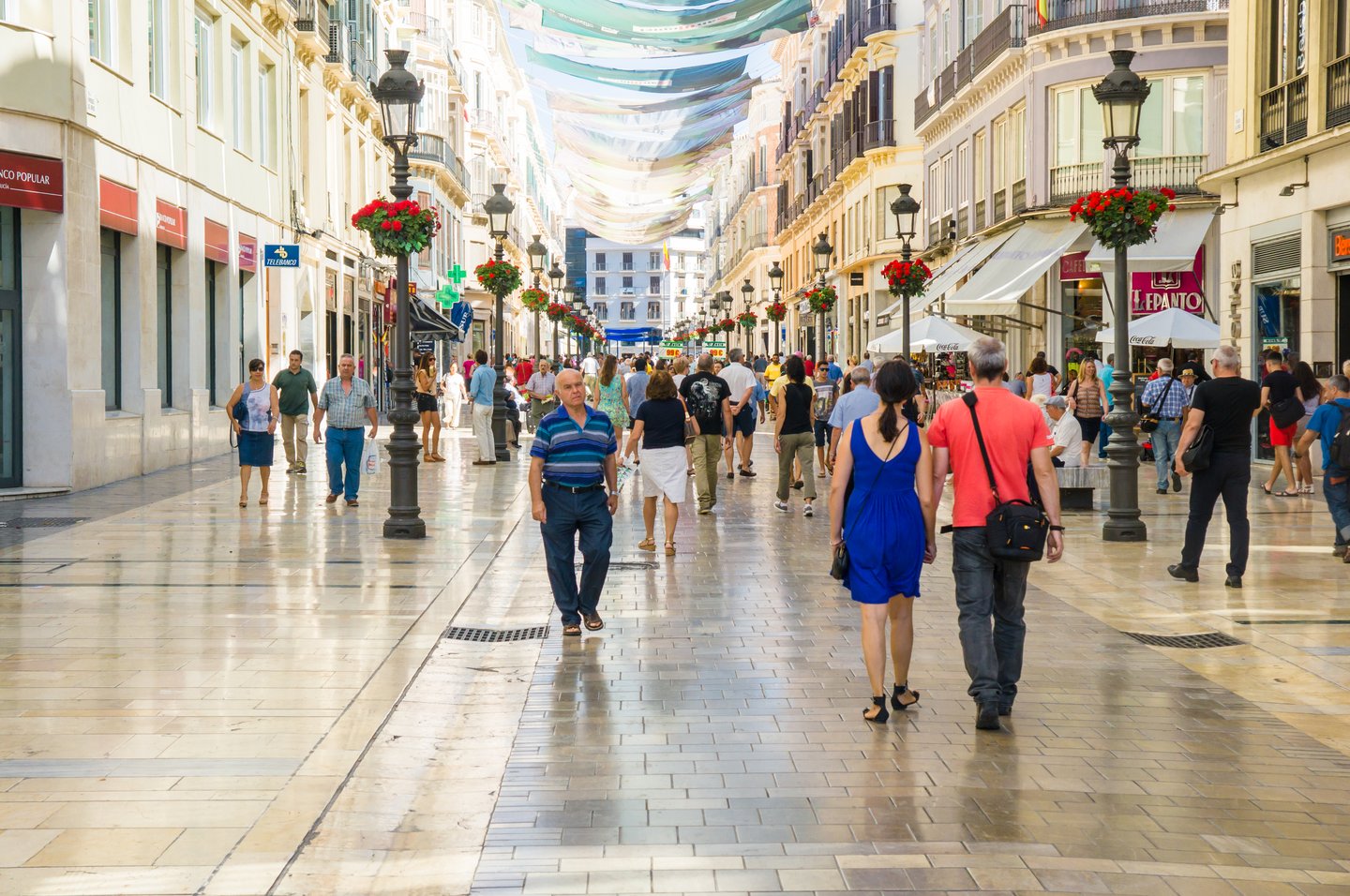 People walking down the street in the historic centre of Malaga