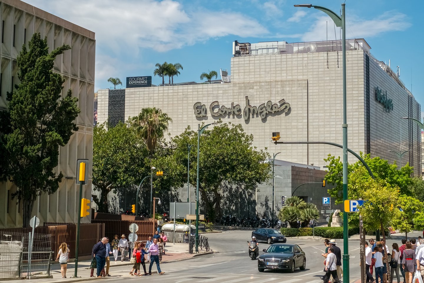 People walking down the road near the store El Corte Ingles department store in Malaga