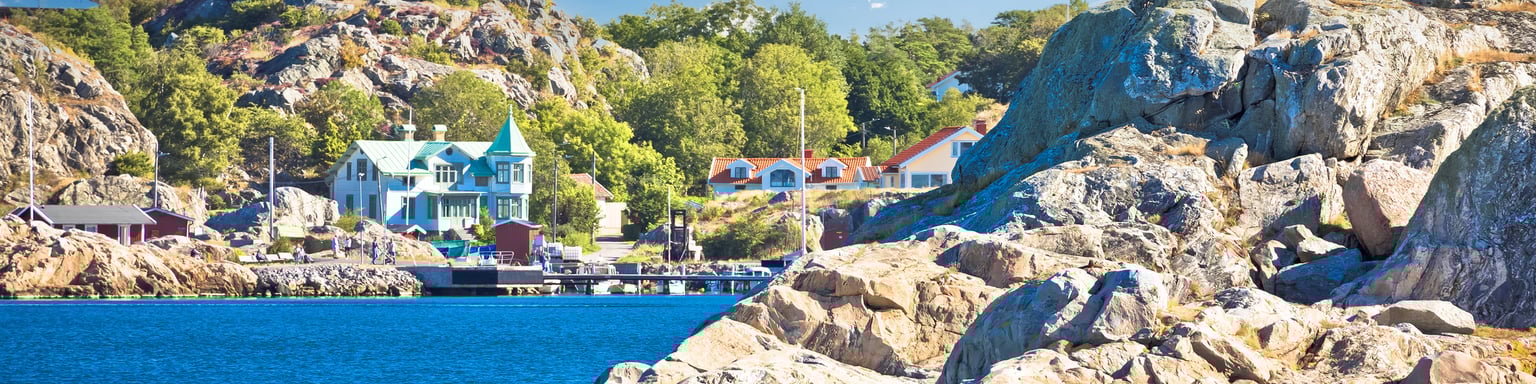 Houses and trees on the coastline of Brännö Island in Gothenburg Archipelago